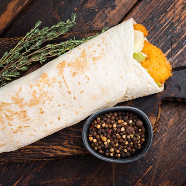 Seafood Shawarma wrap with shrimps, prawns and veggies. wooden background. top view.